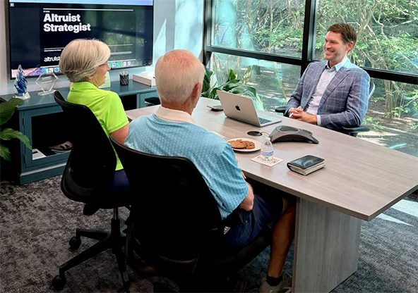 Brandon at desk facing clients